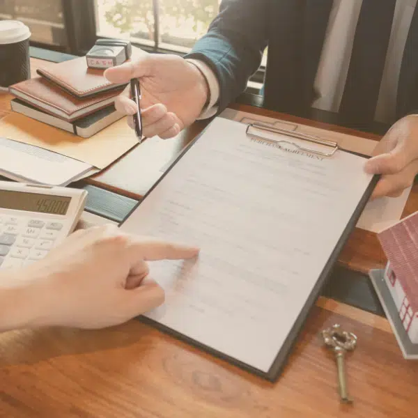 business attorney in friendswood texas an attorney and a client reviewing a document together with the client pointing at the paper on a clipboard