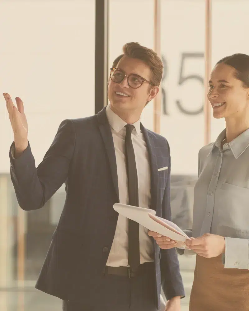 Business Lawyer in Friendswood Texas with Client two people smiling and looking in a single direction at something out of frame