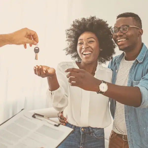 real estate attorney in friendswood texas a couple receiving keys and smiling